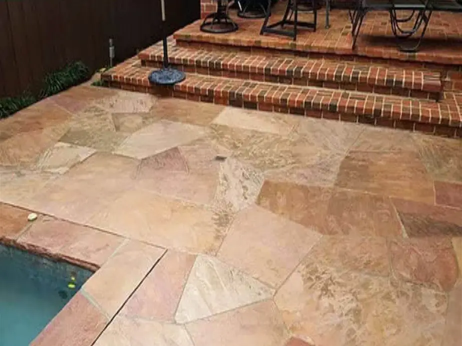 Flagstone pool deck and brick steps washed back to warm sandstone colour